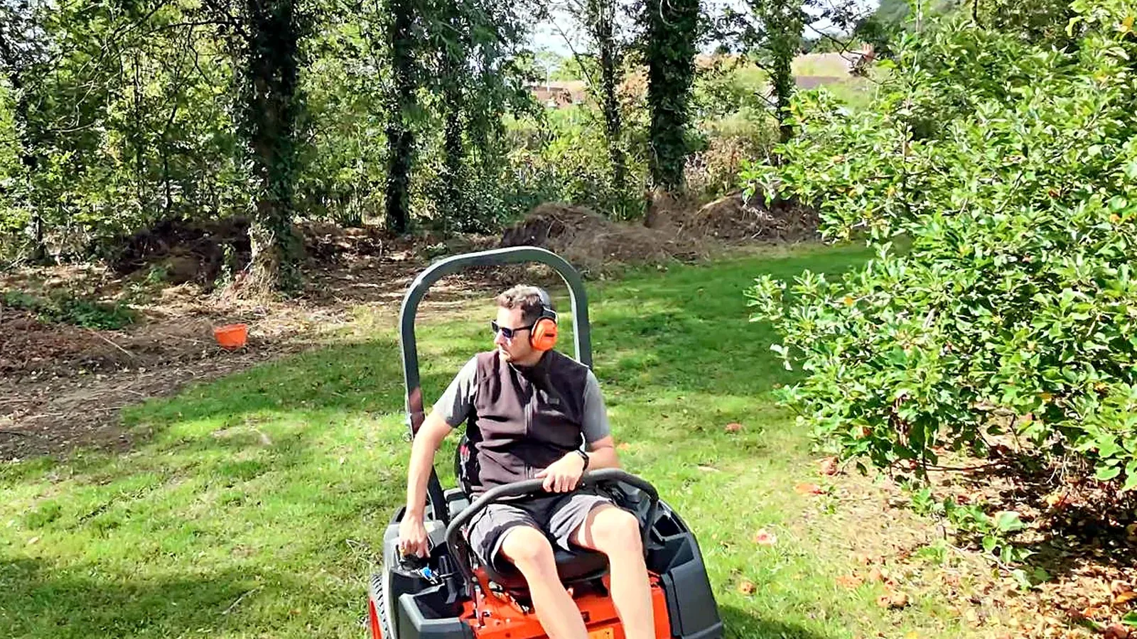The zero turn mower on a lawn under the trees