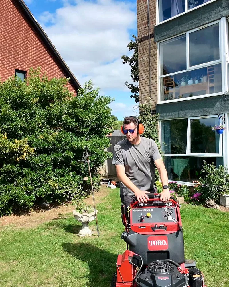 Tom mowing a lawn on the Toro stand-on mower