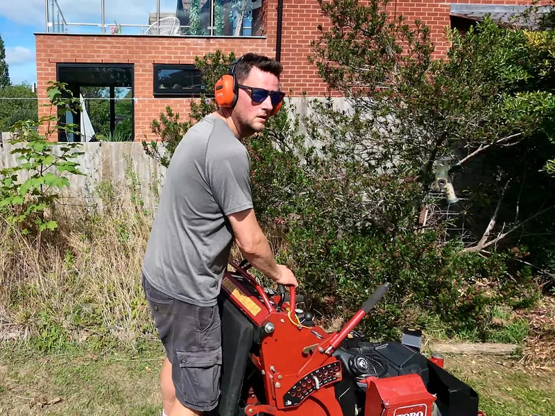 The stand-on mower on an overgrown garden
