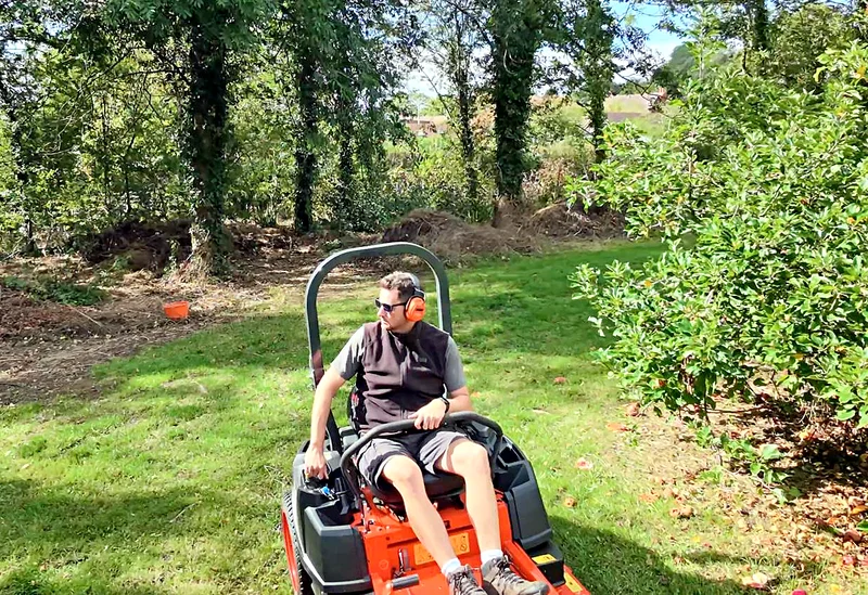 The zero turn on a lawn under the trees